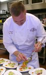 Chef plating red curry salmon.JPG